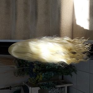 Brand new long synthetic bleached blond wig with loose curls